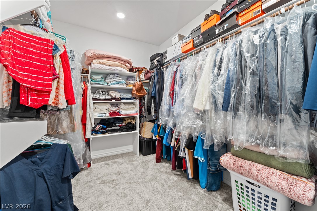 8879 Roadrunner Ravine Street Las Vegas, NV 89166 - Photo 25 of 39 Custom built-in shelving offers smart storage solutions within this well-appointed walk-in closet.