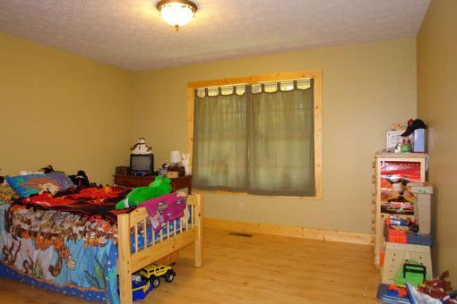 569 Sam Reed Road Northwest Floyd, VA 24091 - Photo 11 of 22 a bedroom with a bed and a window
