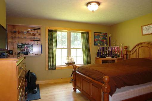 569 Sam Reed Road Northwest Floyd, VA 24091 - Photo 12 of 22 a bedroom with a bed and wooden floor