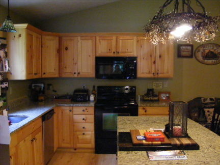 569 Sam Reed Road Northwest Floyd, VA 24091 - Photo 7 of 22 a kitchen with stainless steel appliances granite countertop a stove a sink and a microwave