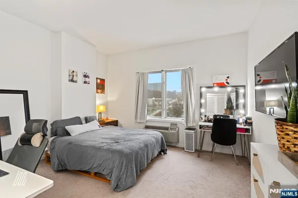 a bedroom with a bed and a couch