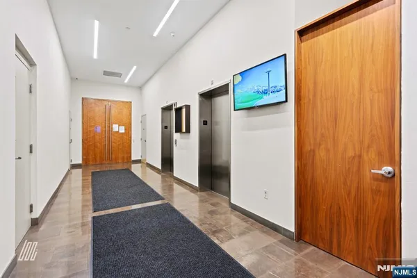 a view of a hallway with wooden shelves