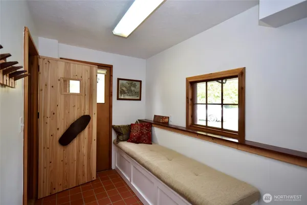 a hallway with a large window and a couch