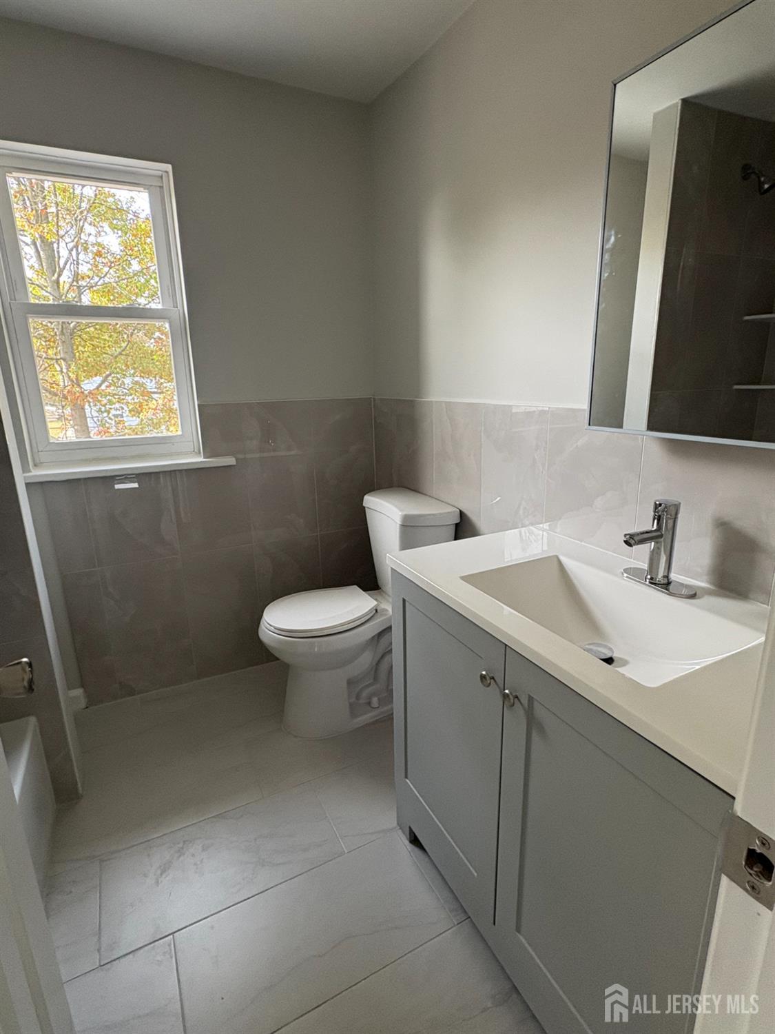 111 Doyle Street Piscataway, NJ 08854 - Photo 17 of 18 a bathroom with a sink toilet and mirror
