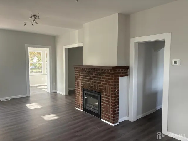 a room with wooden floors and fireplace
