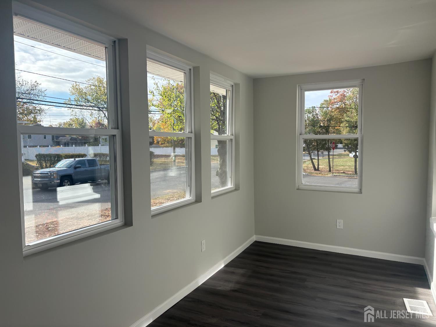 111 Doyle Street Piscataway, NJ 08854 - Photo 9 of 18 a view of an empty room with wooden floor and a window