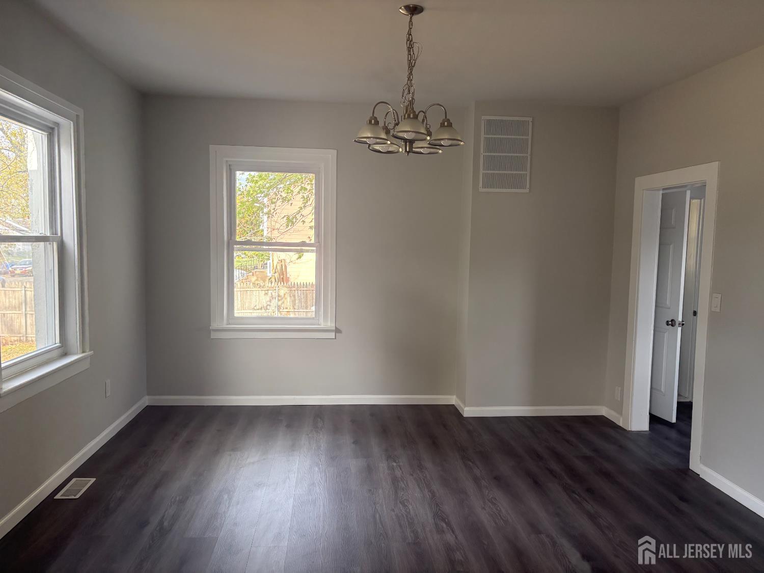 111 Doyle Street Piscataway, NJ 08854 - Photo 10 of 18 a view of a room with wooden floor chandelier and window