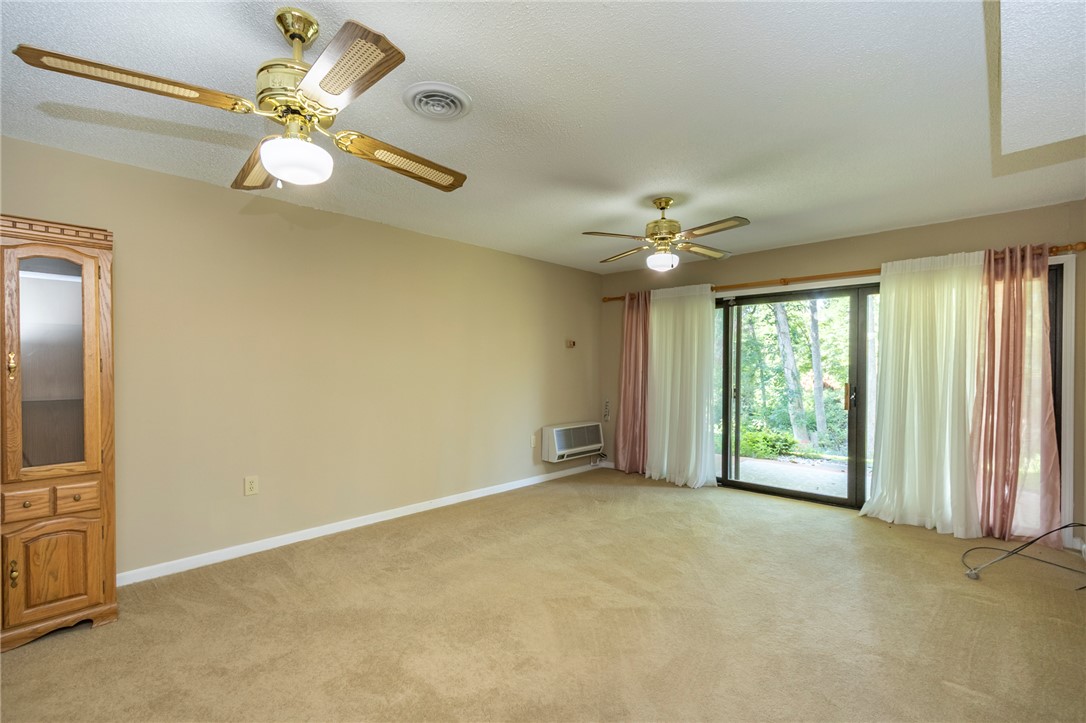 1302 Leeward Road Anderson, SC 29625 - Photo 31 of 50 The carpeted living space features sliding glass doors opening to the serene outdoors.