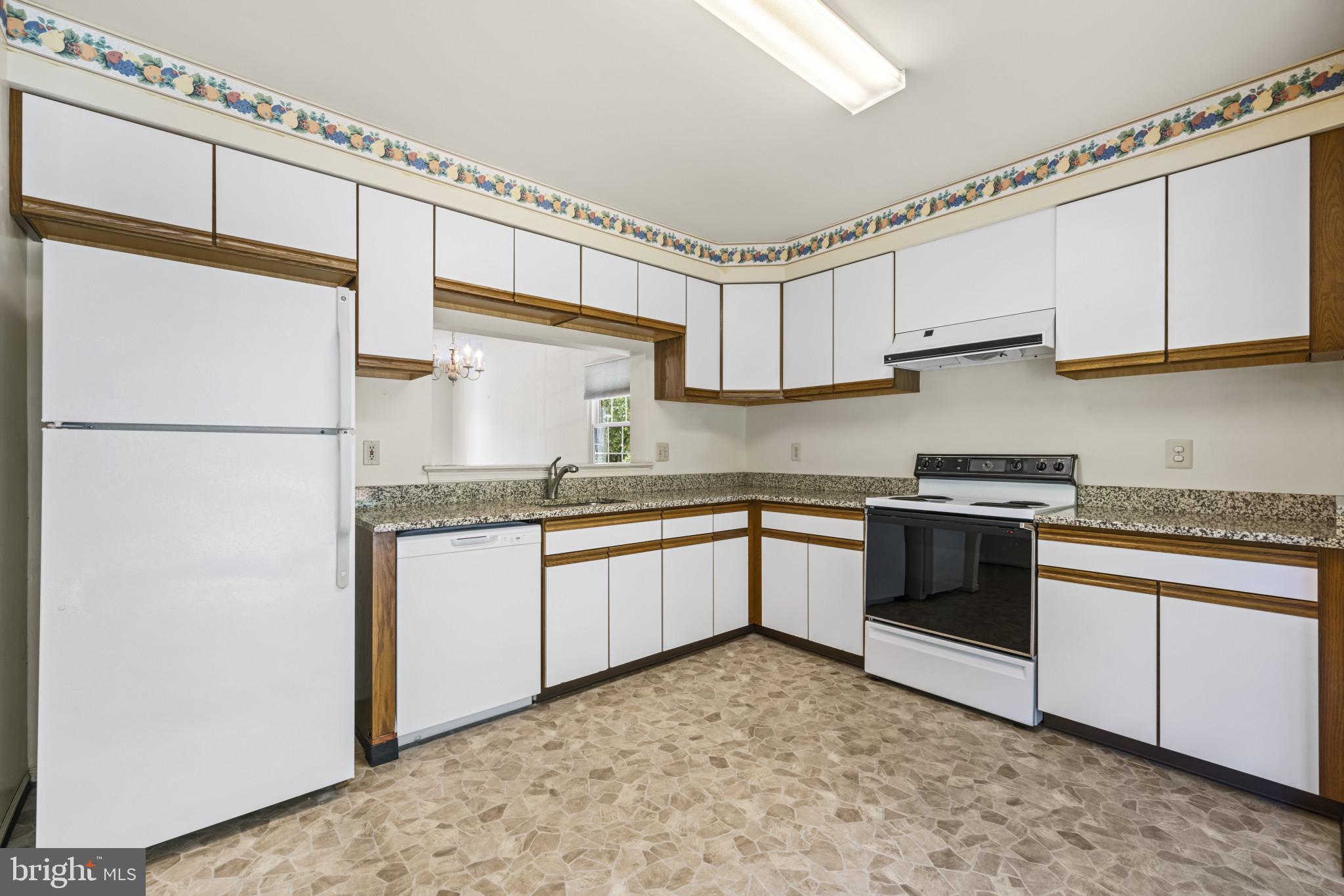 4031 Forest Valley Road Baltimore, MD 21234 - Photo 11 of 30 a kitchen with granite countertop a sink cabinets stainless steel appliances and a window
