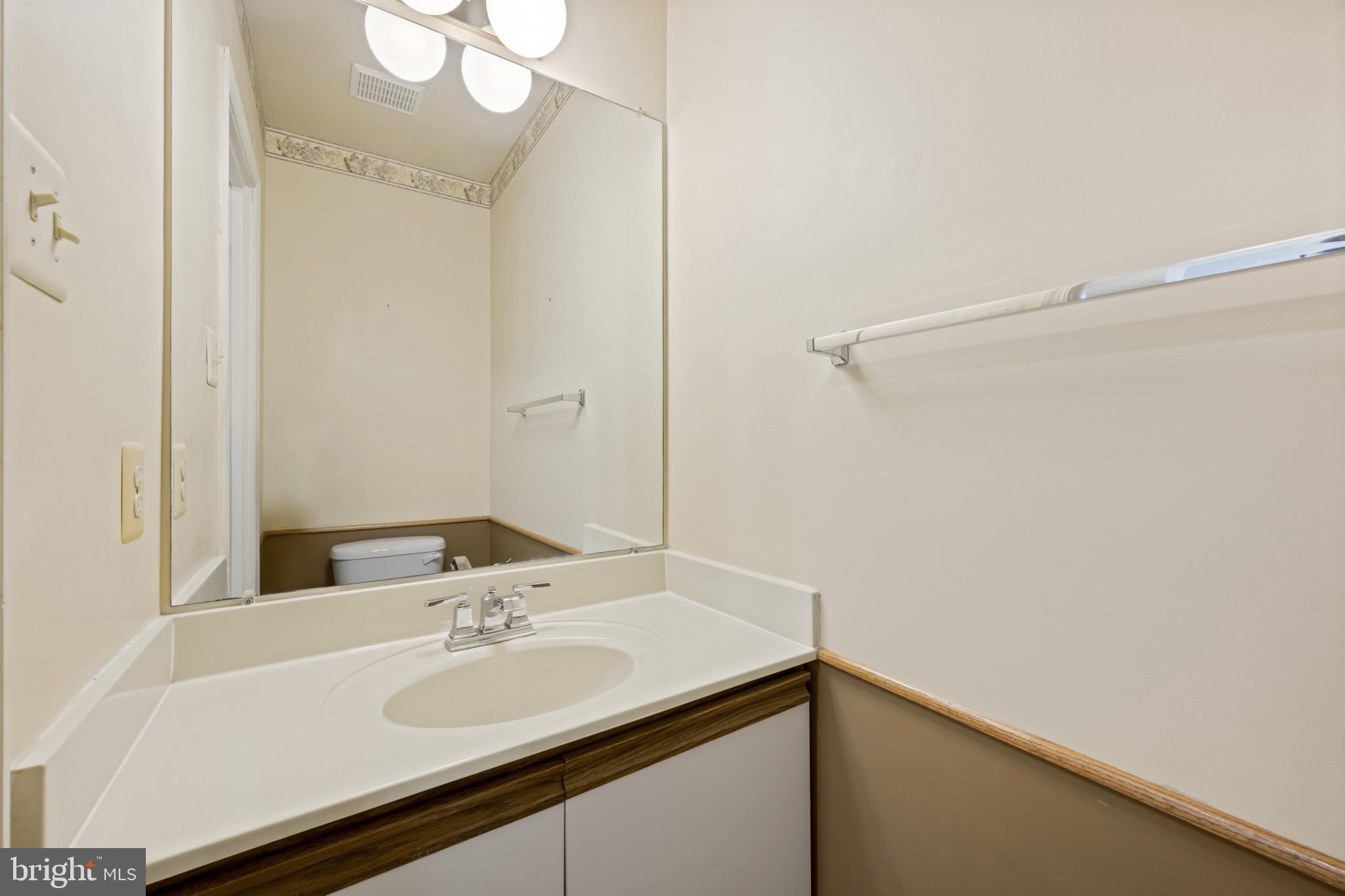 4031 Forest Valley Road Baltimore, MD 21234 - Photo 13 of 30 a bathroom with a sink and a mirror