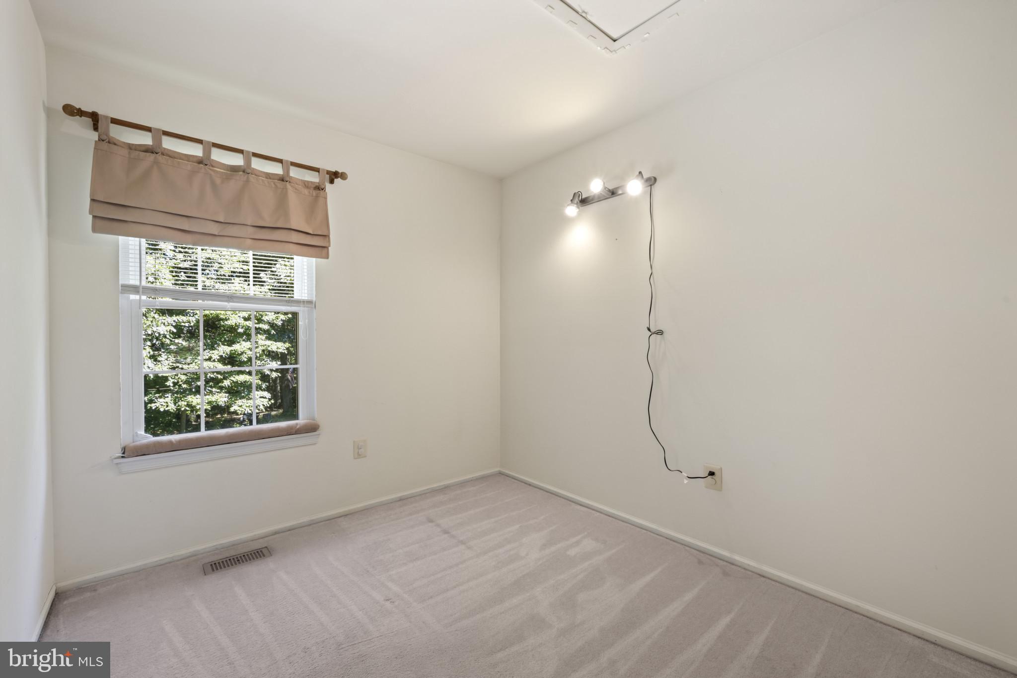 4031 Forest Valley Road Baltimore, MD 21234 - Photo 14 of 30 a view of an empty room with window and bathroom