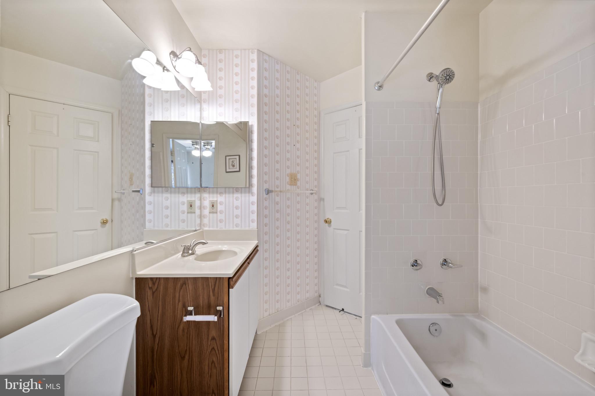 4031 Forest Valley Road Baltimore, MD 21234 - Photo 19 of 30 a bathroom with a sink a toilet and shower