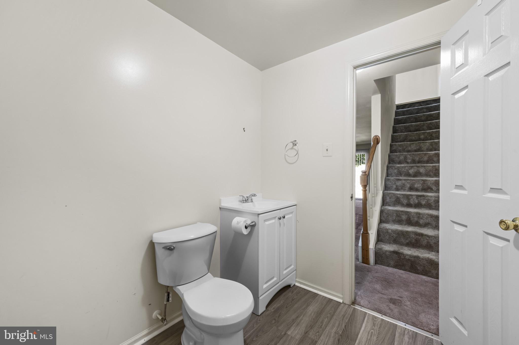 4031 Forest Valley Road Baltimore, MD 21234 - Photo 21 of 30 a white toilet sitting next to a bathroom sink