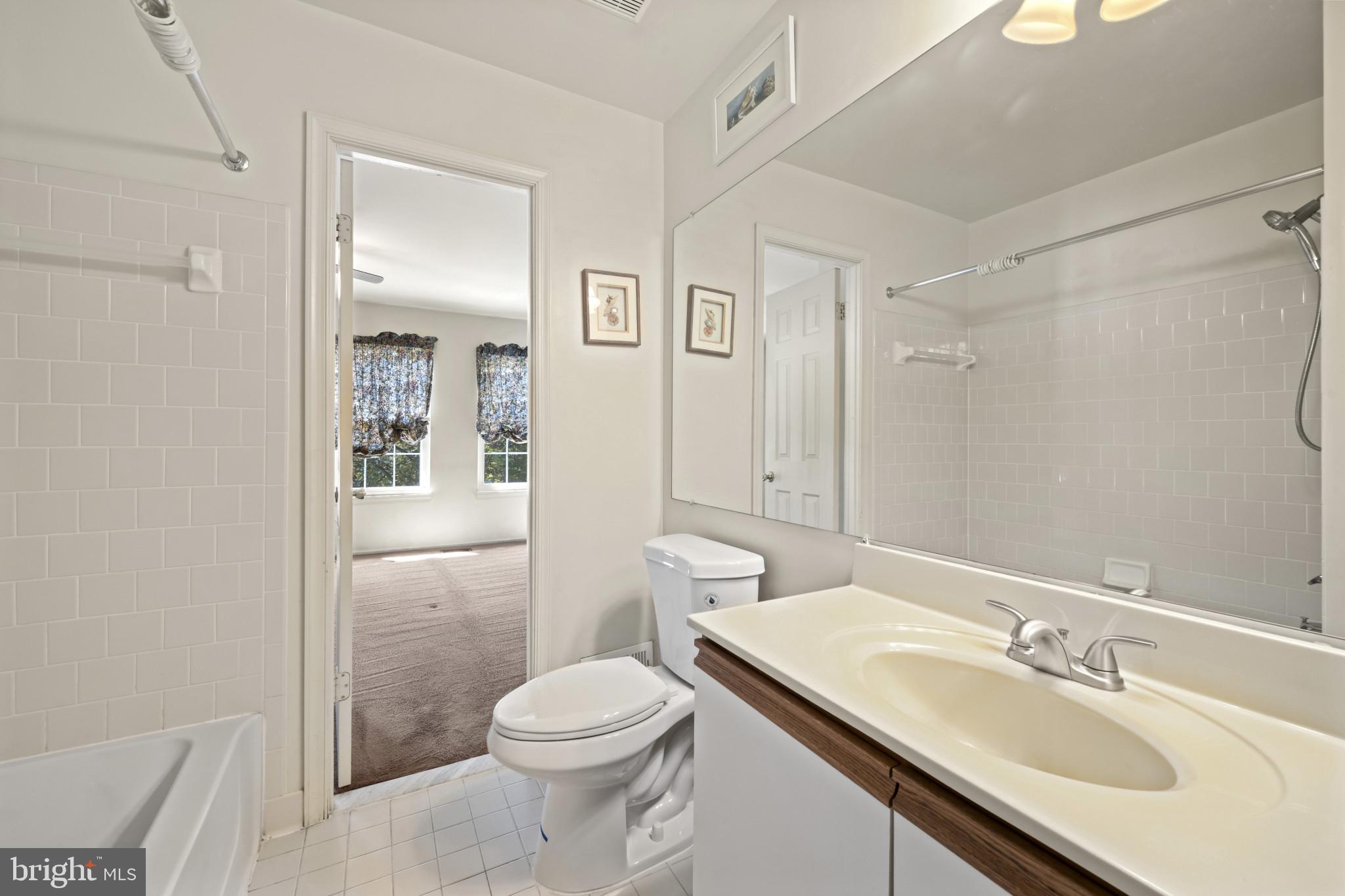 4031 Forest Valley Road Baltimore, MD 21234 - Photo 22 of 30 a bathroom with a sink a toilet and shower