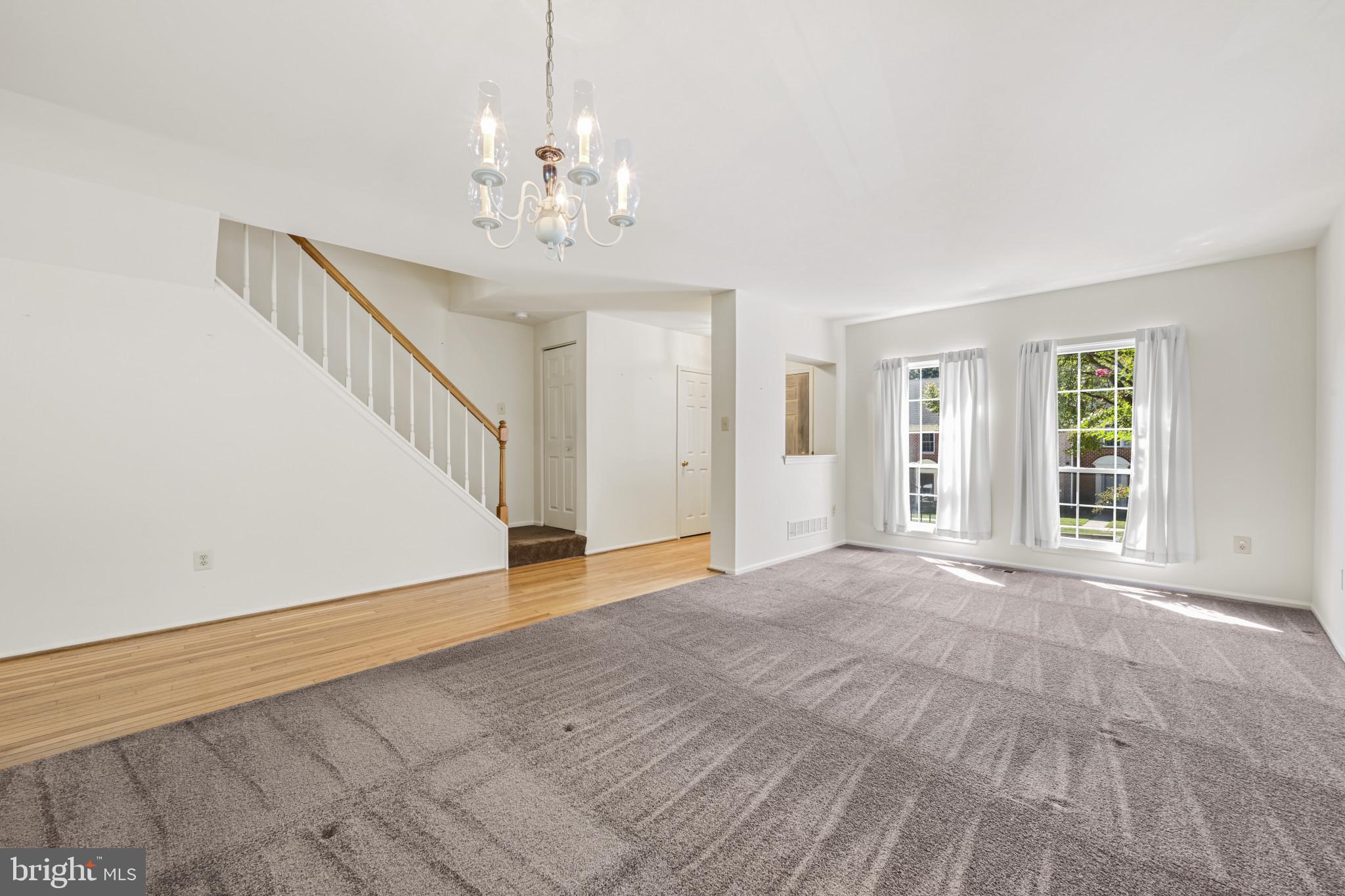 4031 Forest Valley Road Baltimore, MD 21234 - Photo 5 of 30 a view of an empty room with wooden floor and a window