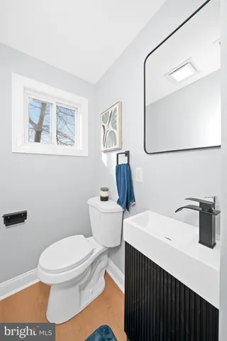 a white toilet sitting next to a bathroom sink