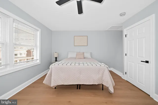 a bed sitting in a bedroom next to a window