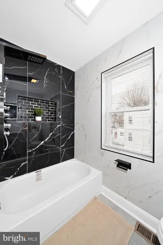 a bathroom with a bathtub and a shower