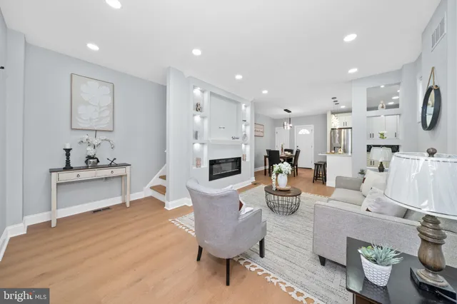 a living room with fireplace furniture and a wooden floor