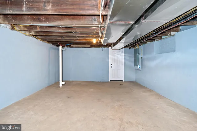 a front view of a building with cars parked