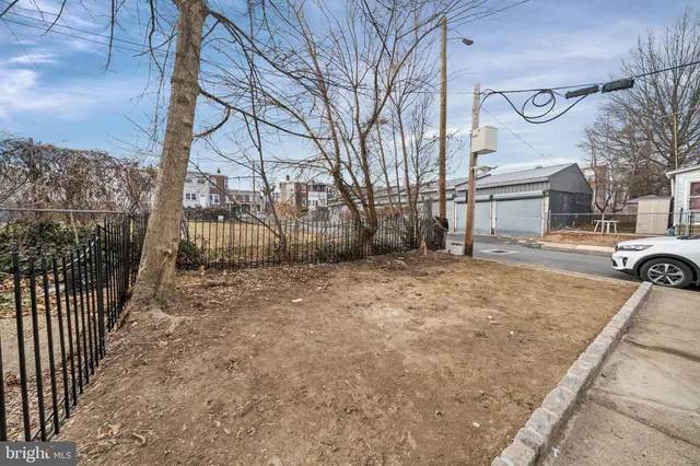 a view of a backyard with a fence