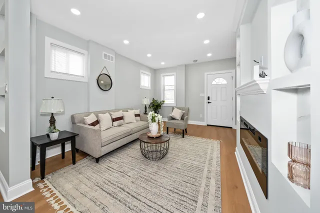 a living room with furniture and a fireplace