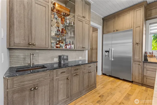 a kitchen with stainless steel appliances granite countertop a refrigerator and a sink