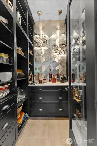 a room with a black white checkered floor with shoes and a large mirror