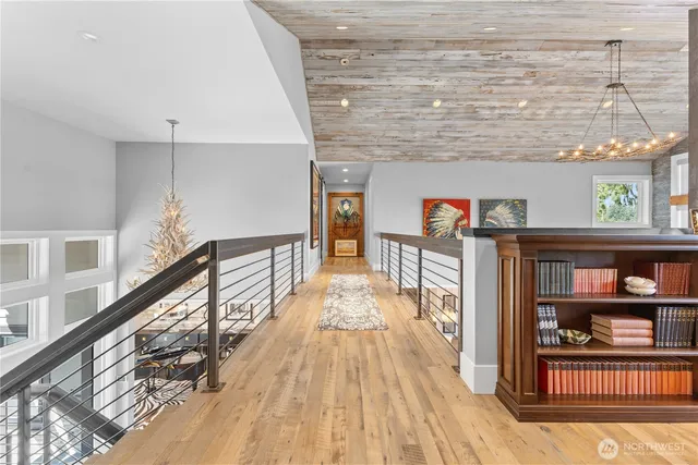 a view of a hallway with wooden floor and staircase