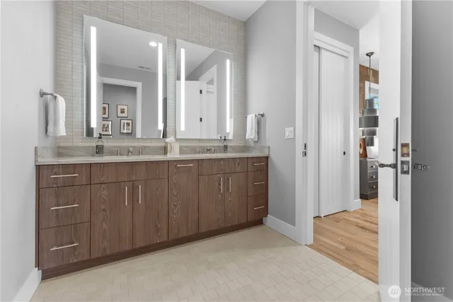 a bathroom with a granite countertop sink and a mirror