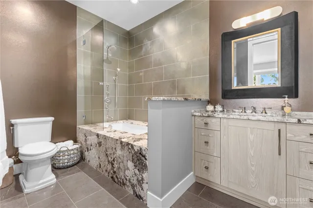 a bathroom with a sink toilet and shower