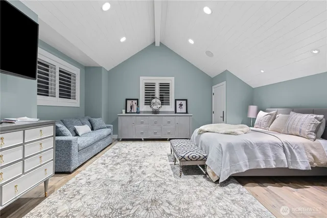 a spacious bedroom with a large bed and a couch