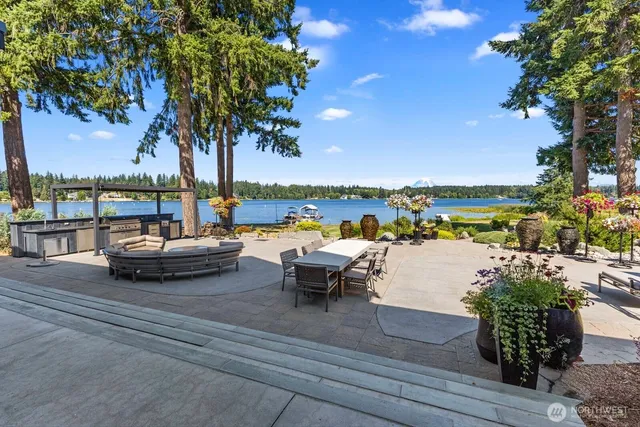 a view of a lake with couches chairs