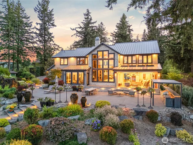 a view of a house with backyard and sitting area