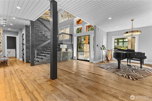 a view of a livingroom with wooden floor and furniture
