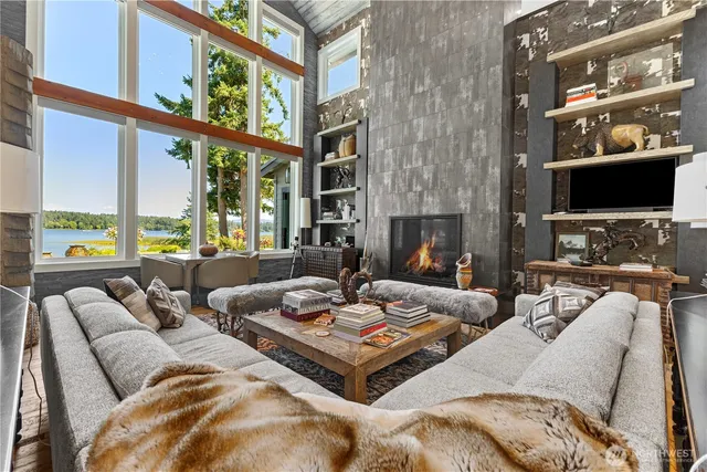 a living room with furniture large window and a flat screen tv
