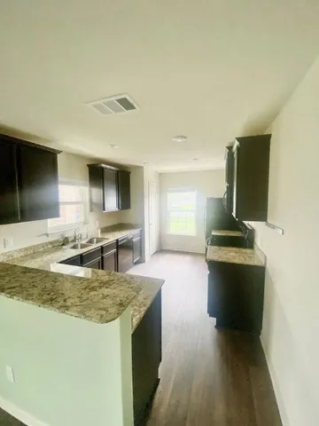 a kitchen with kitchen island stainless steel appliances a sink stove and refrigerator
