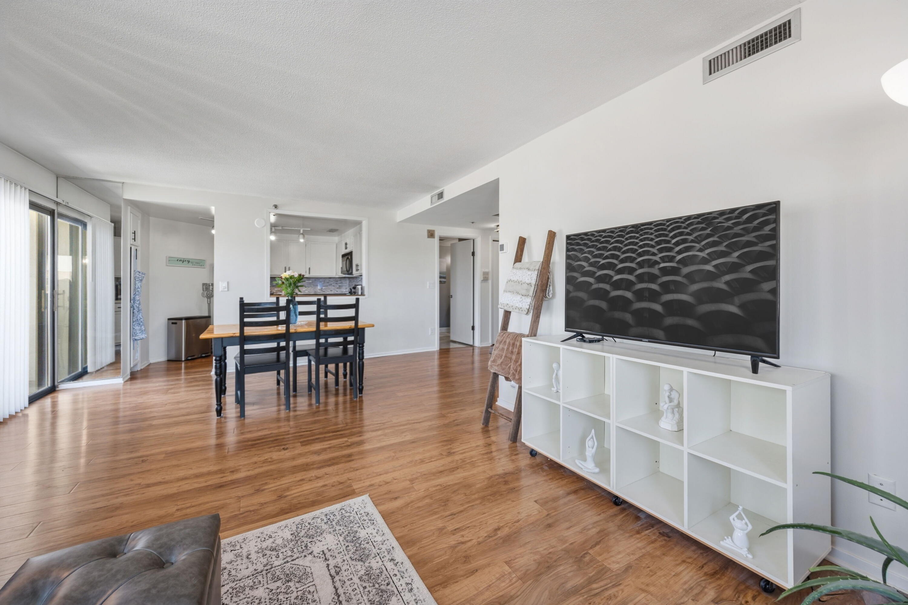 1633 North Prospect Avenue, Unit 5D Milwaukee, WI 53202 - Photo 10 of 38 The living room offers flexible wall space, balcony access nearby, and a smooth connection to the dining area.