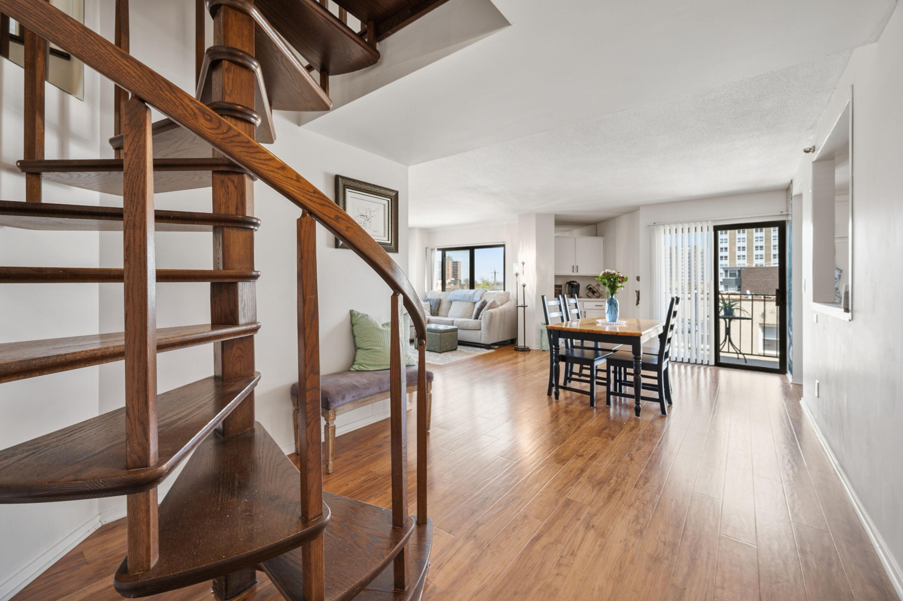1633 North Prospect Avenue, Unit 5D Milwaukee, WI 53202 - Photo 14 of 38 The spiral staircase adds architectural interest while connecting the main living level to the upstairs bedrooms.
