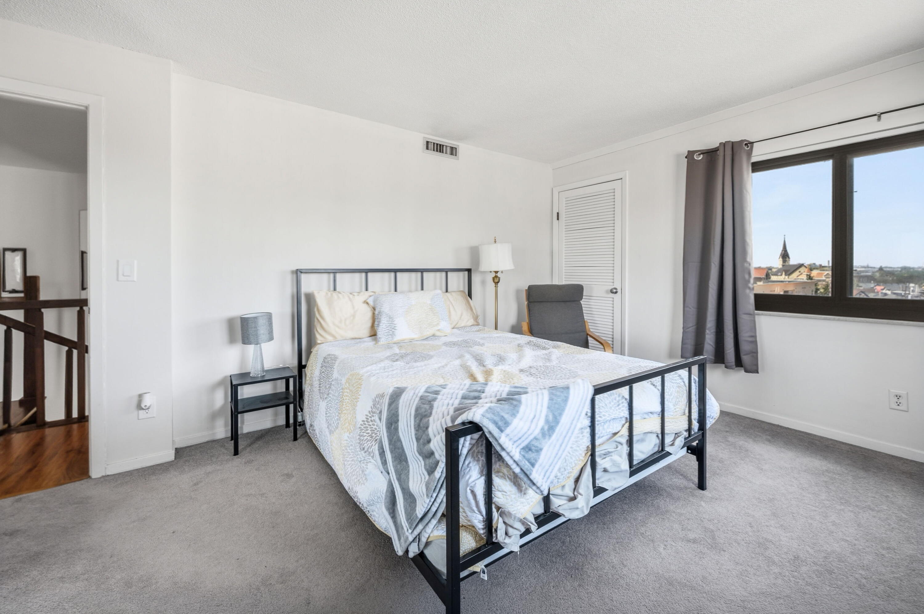 1633 North Prospect Avenue, Unit 5D Milwaukee, WI 53202 - Photo 17 of 38 A wide window brings in natural light and an elevated city outlook, adding an airy feel to the bedroom.