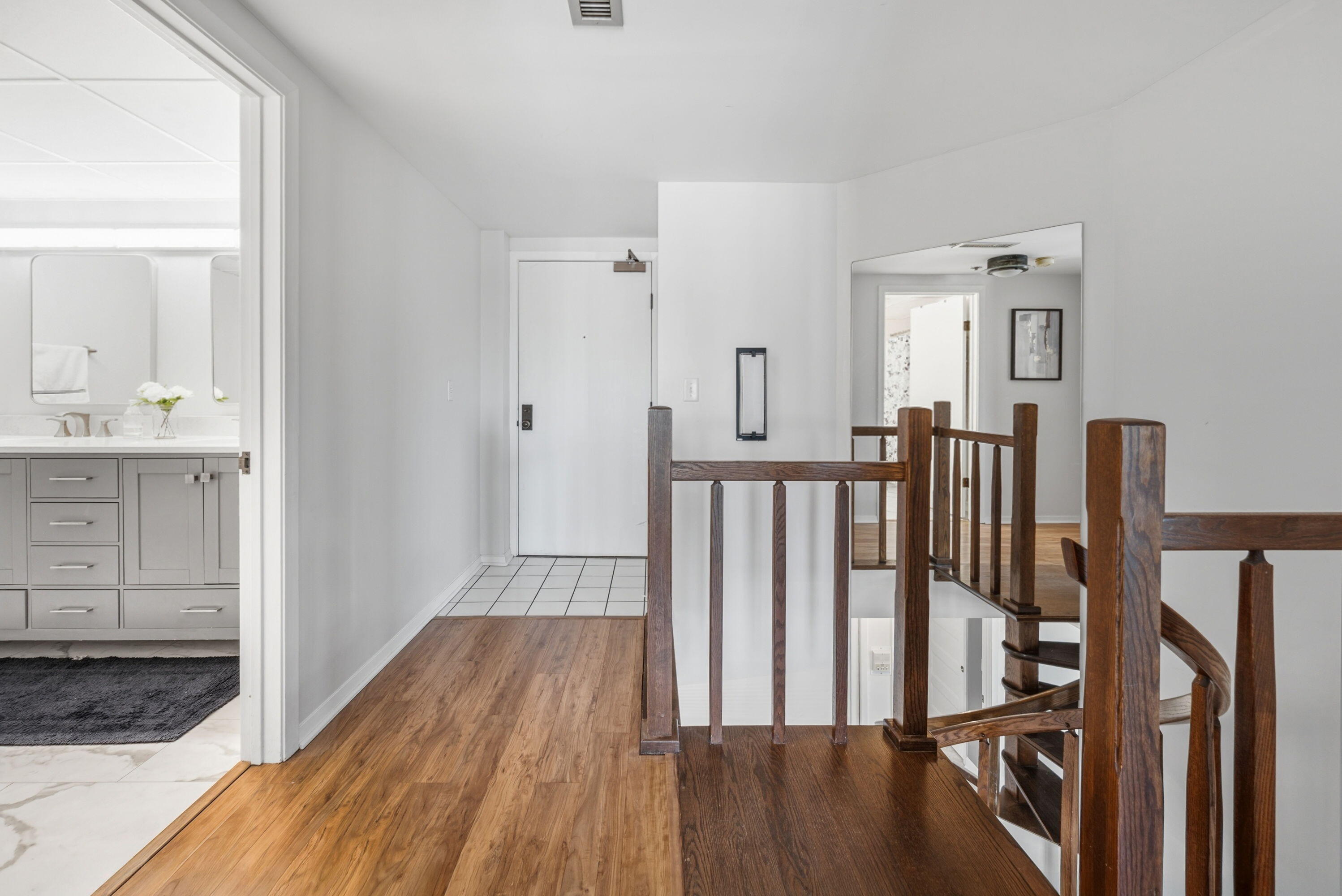 1633 North Prospect Avenue, Unit 5D Milwaukee, WI 53202 - Photo 19 of 38 Warm flooring and a clear hallway layout make the second level feel connected, practical, and easy to navigate.