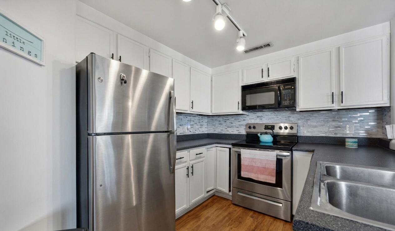 1633 North Prospect Avenue, Unit 5D Milwaukee, WI 53202 - Photo 3 of 38 Fresh white cabinetry, stainless appliances, and an efficient layout make this kitchen easy to enjoy from quick breakfasts to casual dinners. (fridge virtually added, current fridge is white)