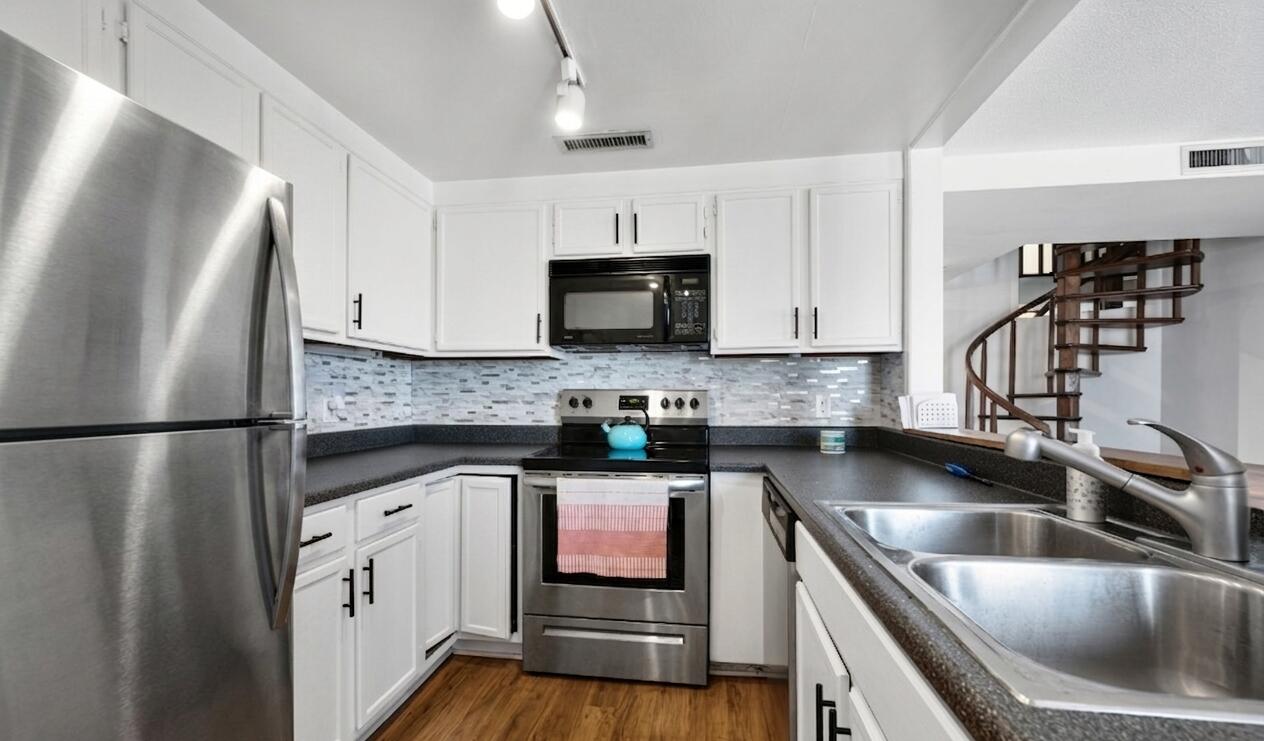1633 North Prospect Avenue, Unit 5D Milwaukee, WI 53202 - Photo 4 of 38 A smart kitchen footprint connects easily to the main living area, keeping cooking, serving, and conversation within reach. (Fridge has been virtually altered- current model is white)
