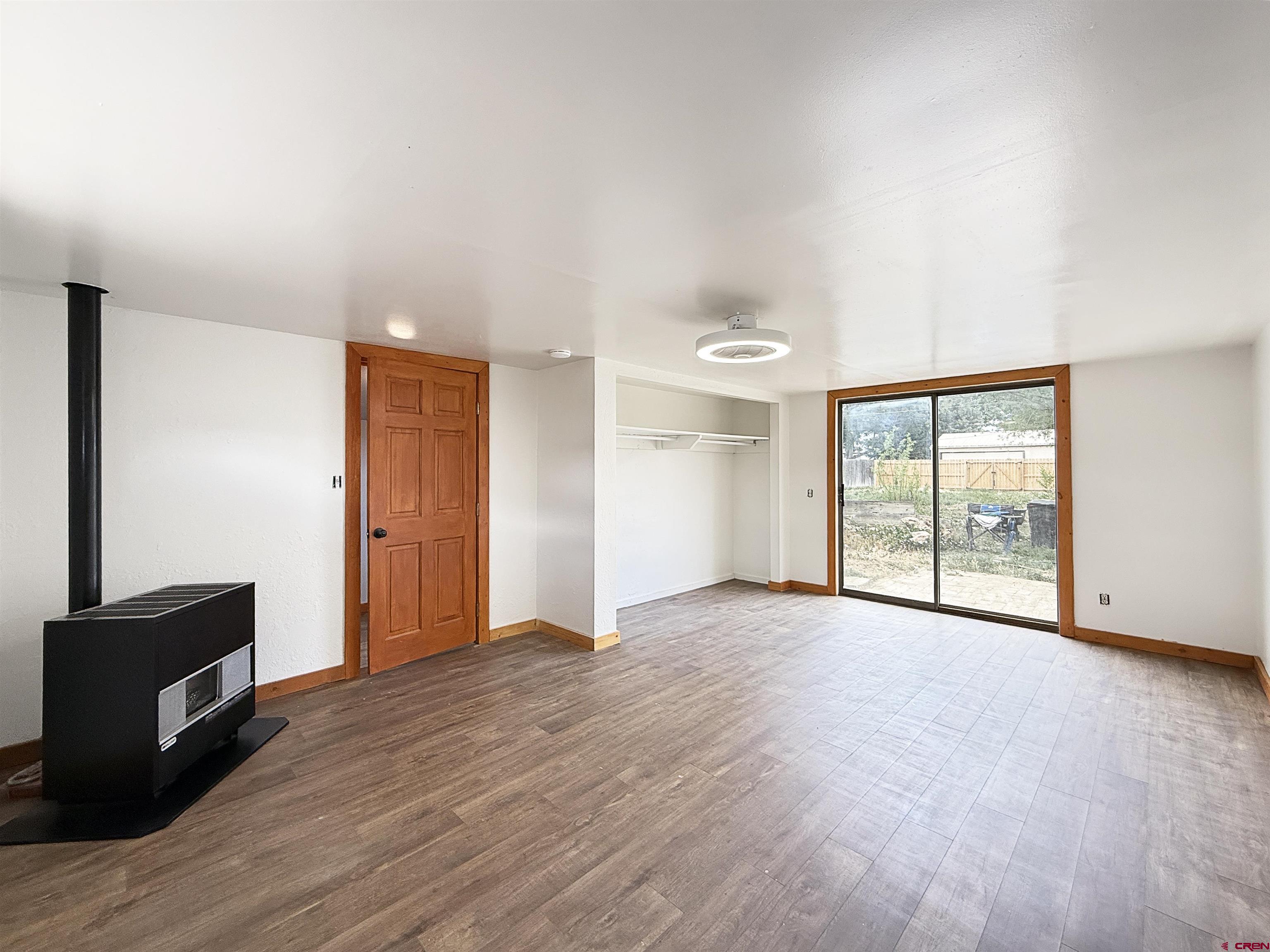 1246 Meeker Street Delta, CO 81416 - Photo 13 of 21 a view of an empty room with wooden floor and a window