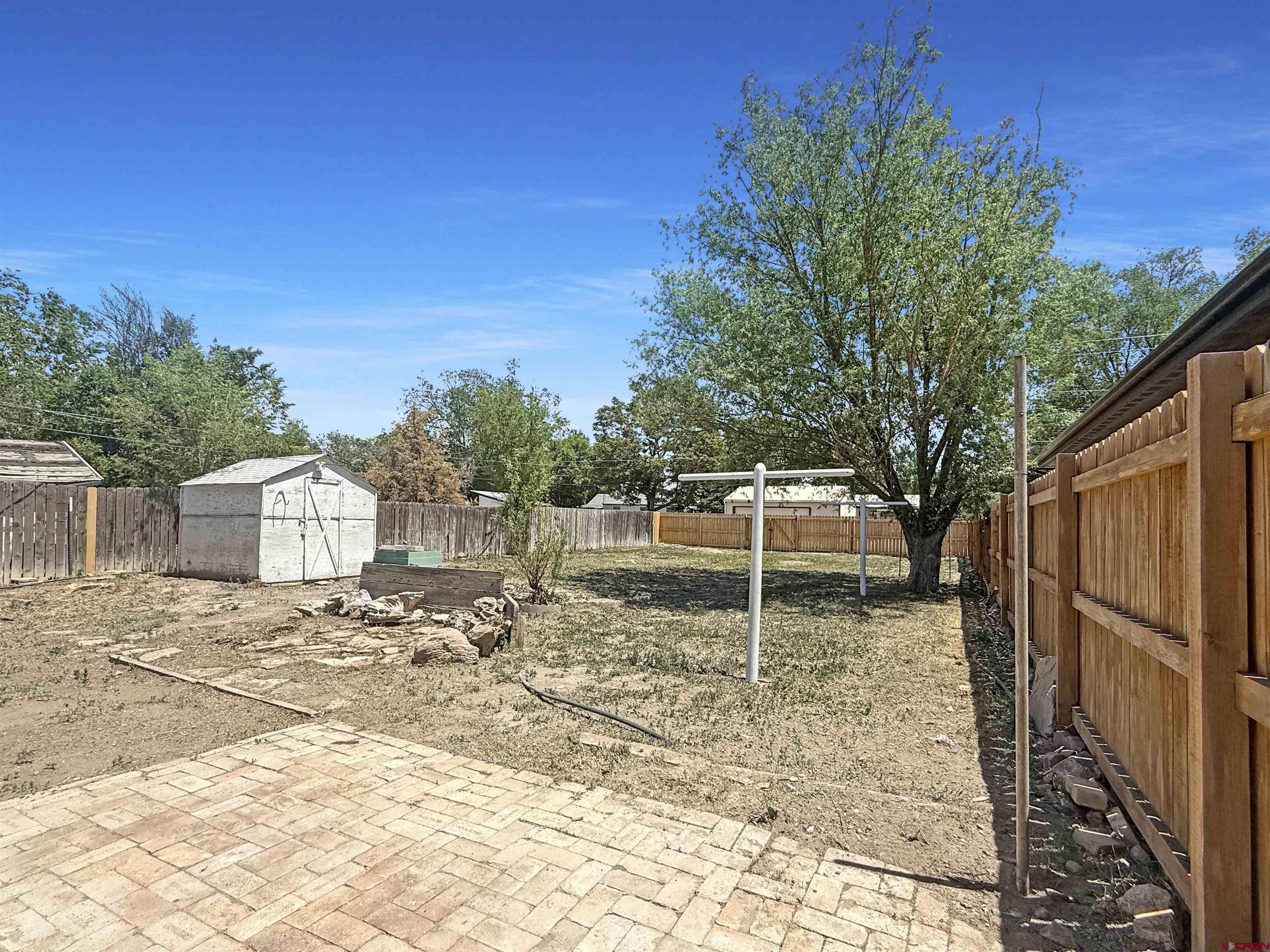 1246 Meeker Street Delta, CO 81416 - Photo 16 of 21 a backyard of a house with table and chairs