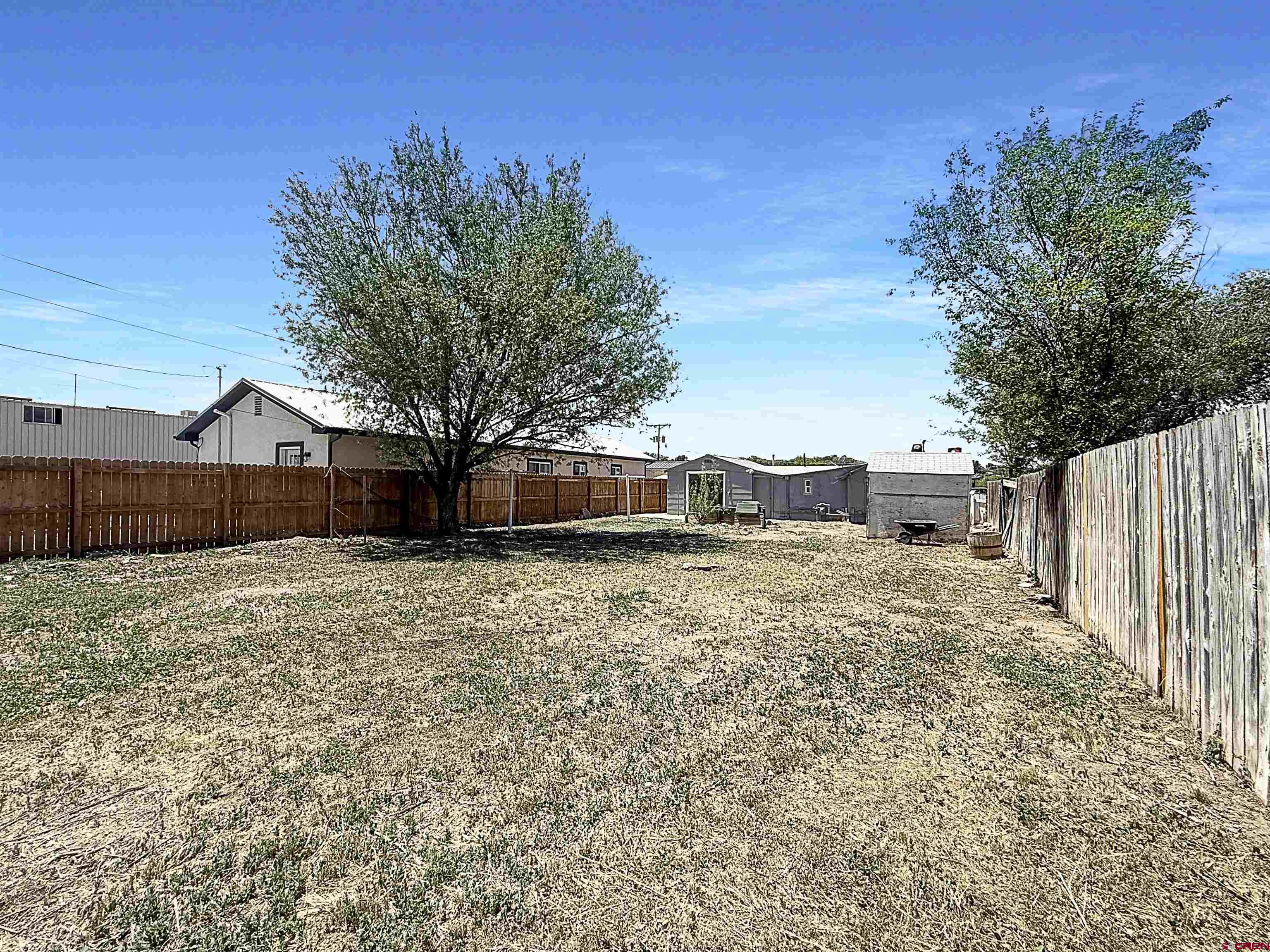 1246 Meeker Street Delta, CO 81416 - Photo 19 of 21 a front view of a house with a yard