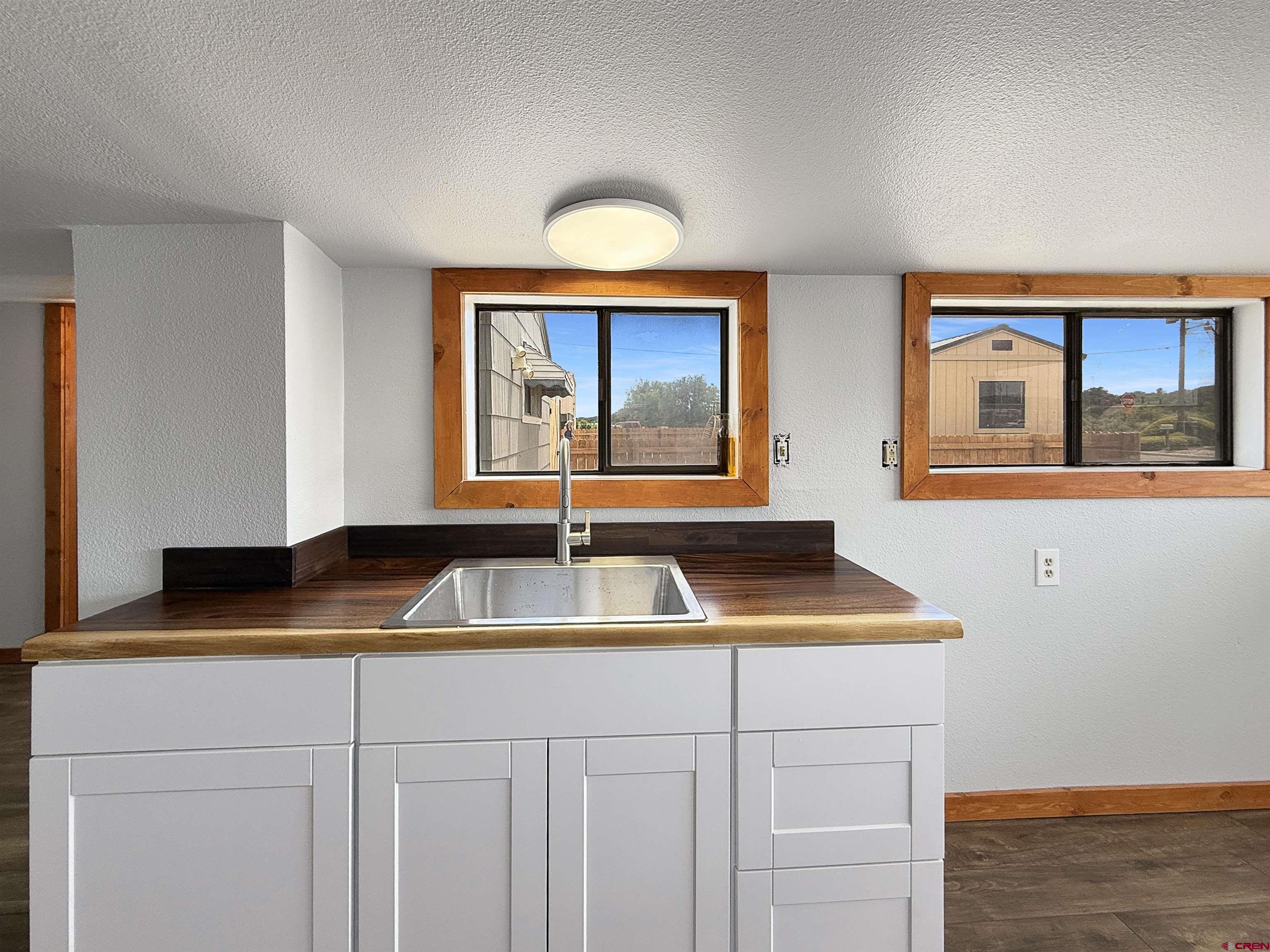 1246 Meeker Street Delta, CO 81416 - Photo 5 of 21 a kitchen with a sink and a cabinet with wooden roofs