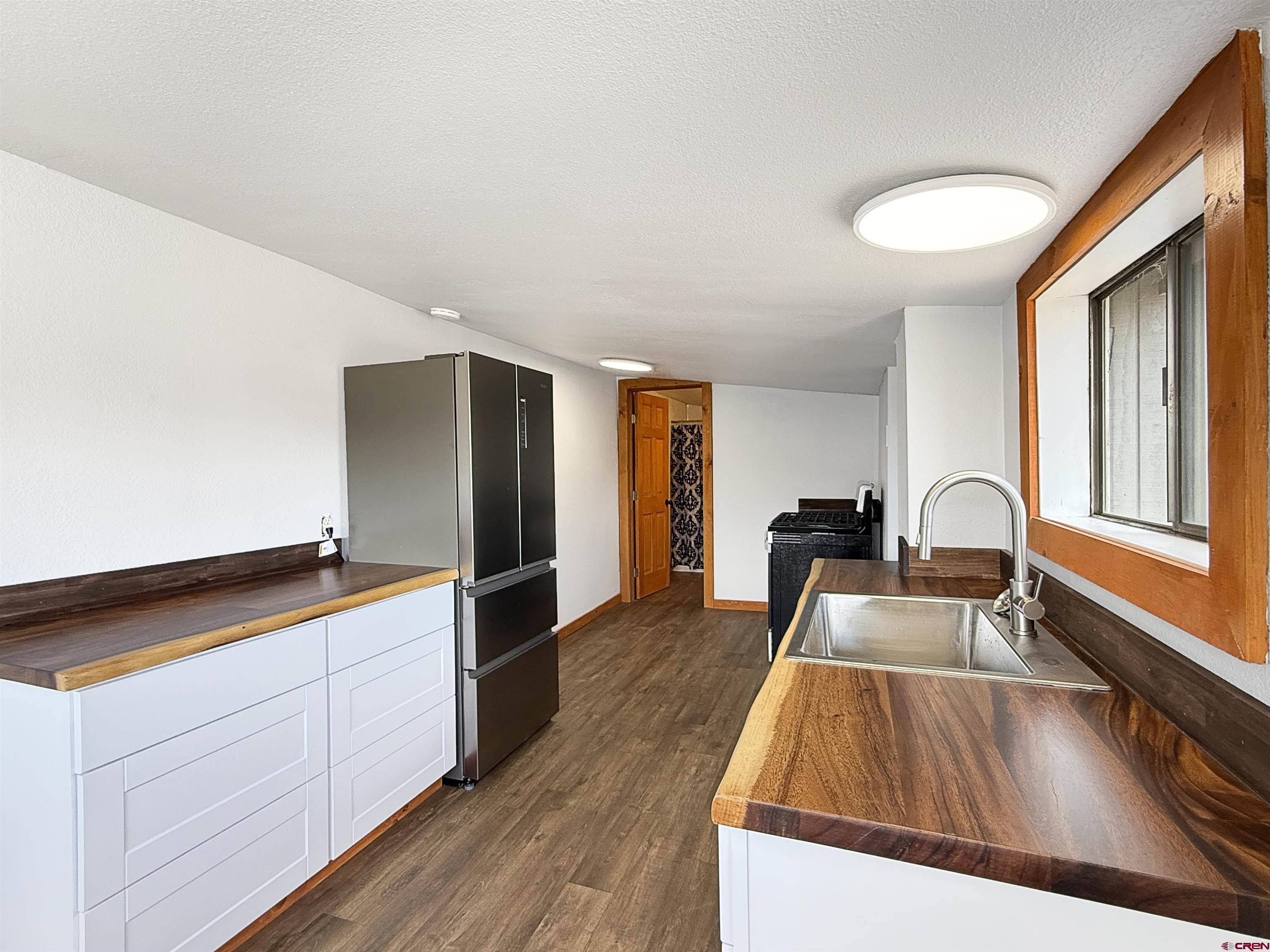 1246 Meeker Street Delta, CO 81416 - Photo 7 of 21 a kitchen view with wooden floor and stainless steel appliances