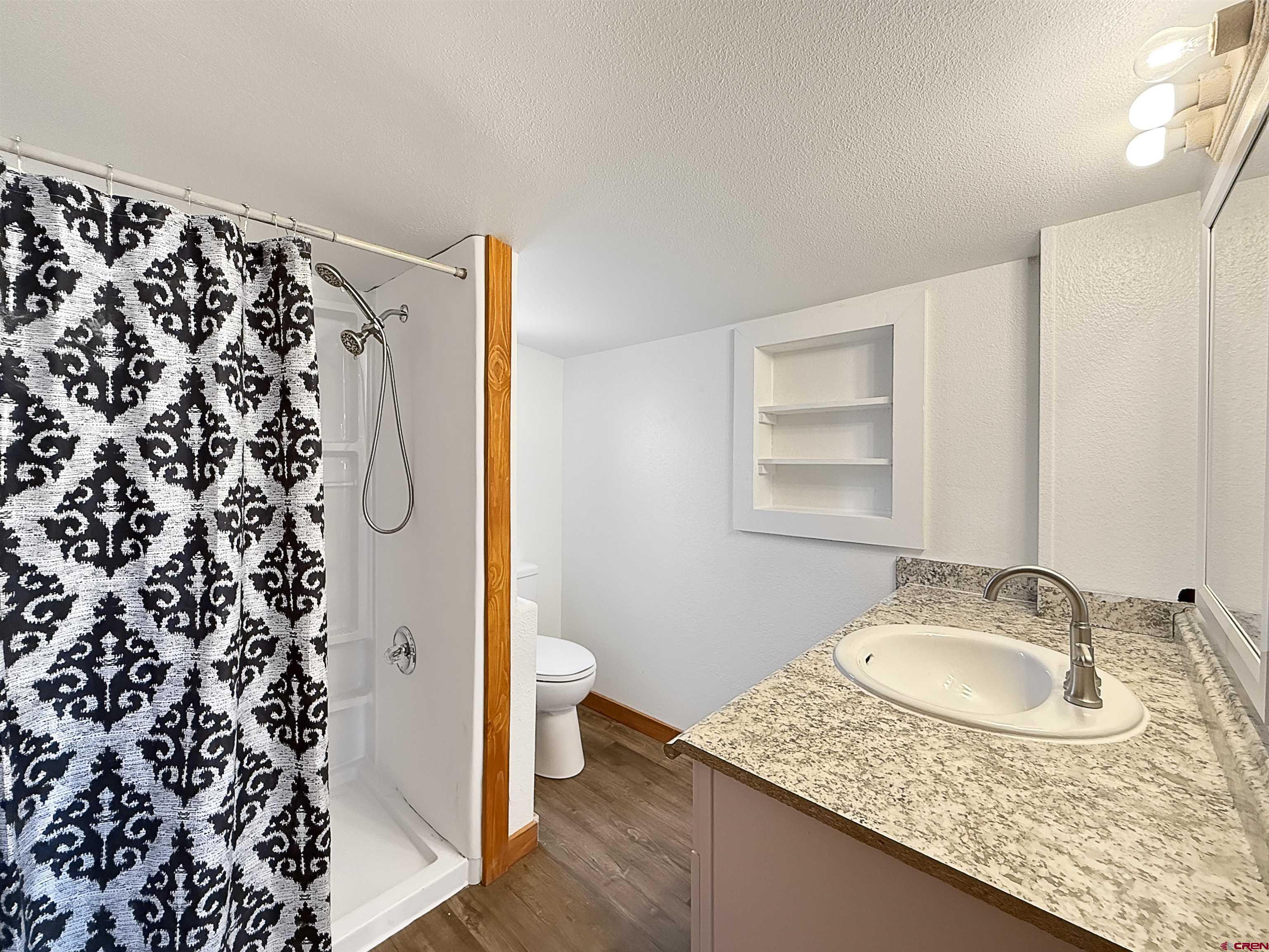1246 Meeker Street Delta, CO 81416 - Photo 9 of 21 a bathroom with a granite countertop sink and a mirror