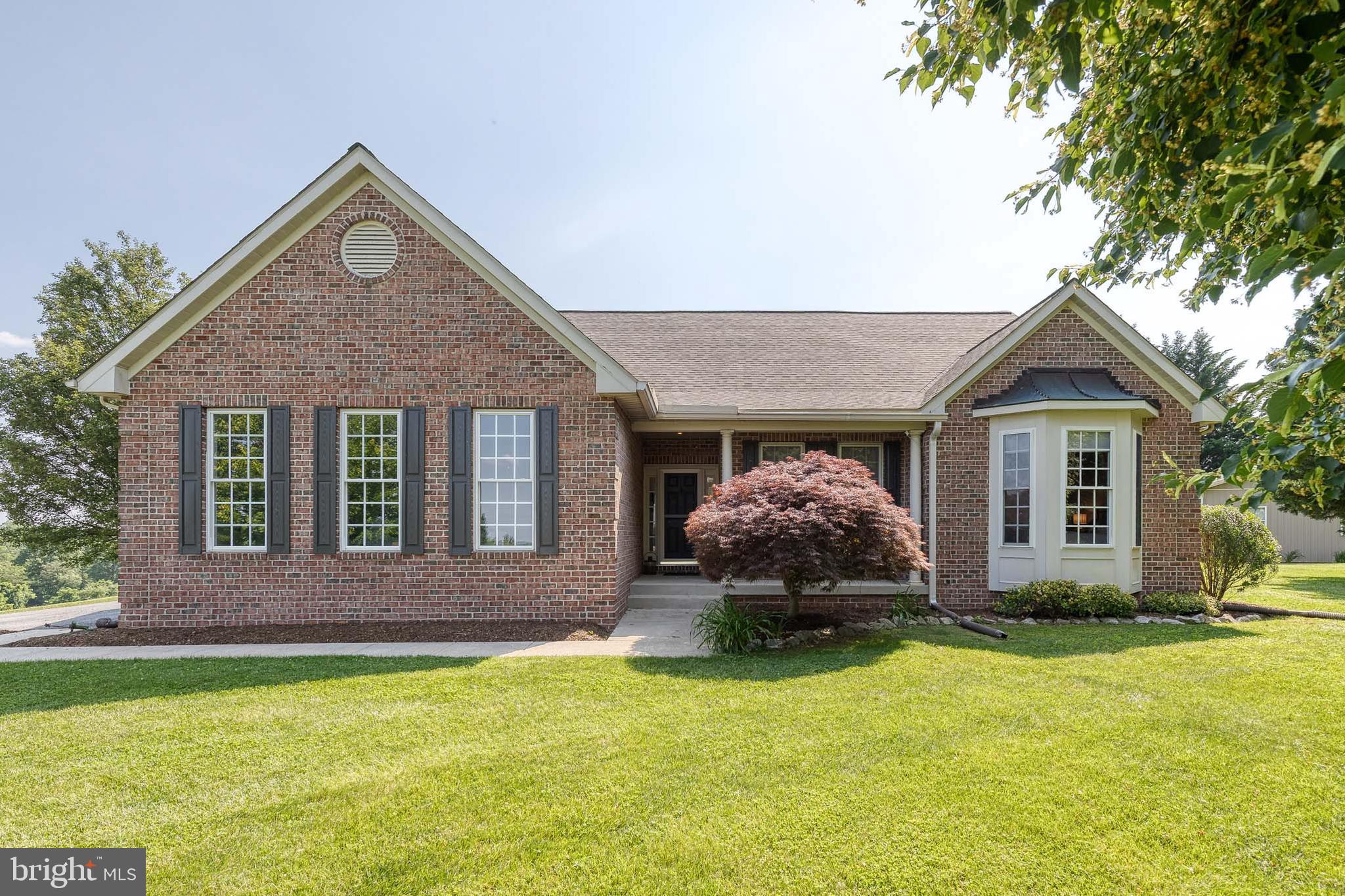 14942 Dover Road Reisterstown, MD 21136 - Photo 1 of 47 a front view of a house with a yard and garage